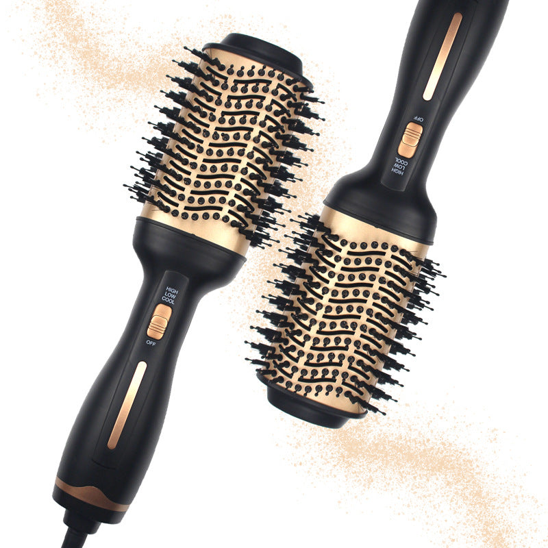 Black and gold hair dryer and round brush set on a white background