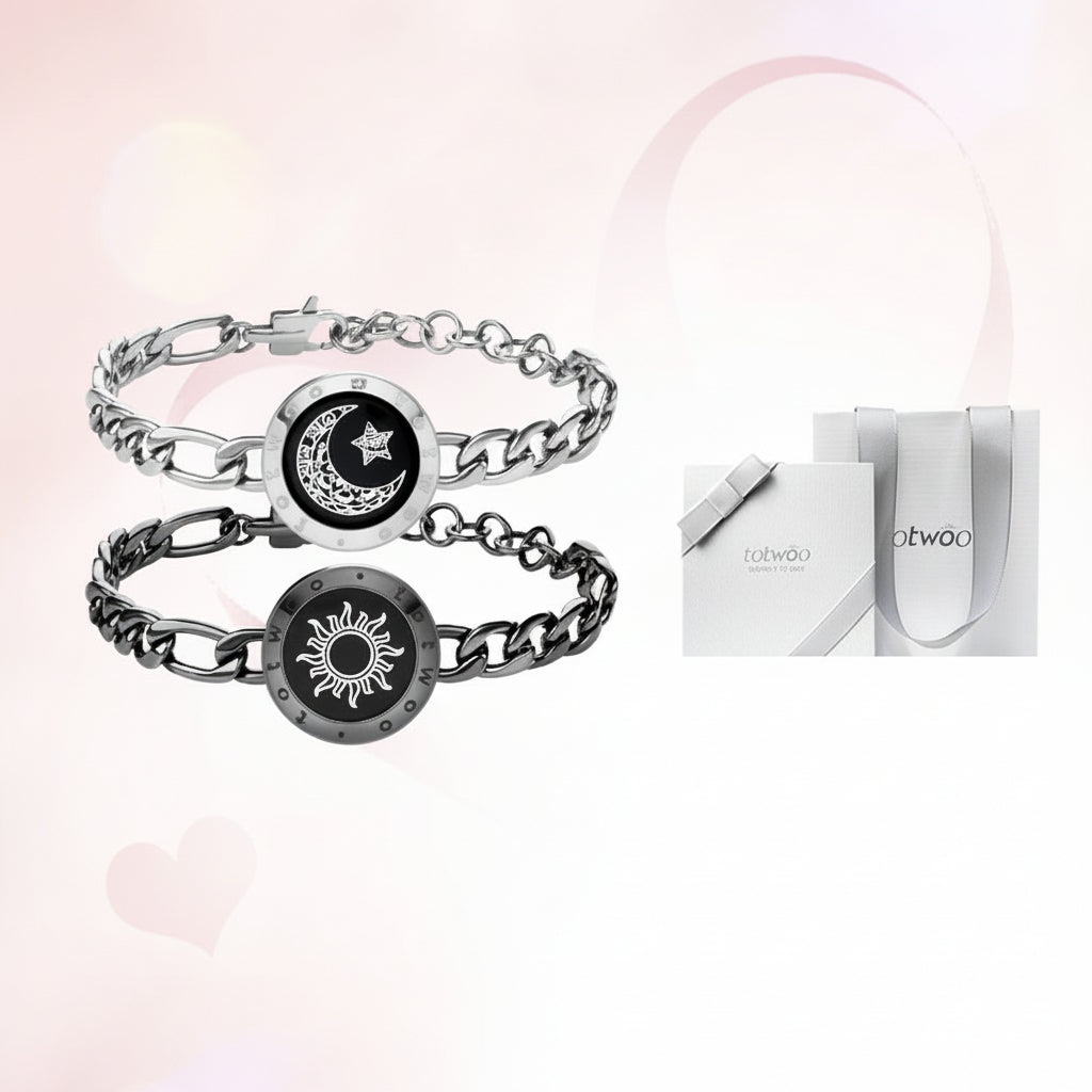 Bracelets with moon and sun designs and a gift box on a light pink background.