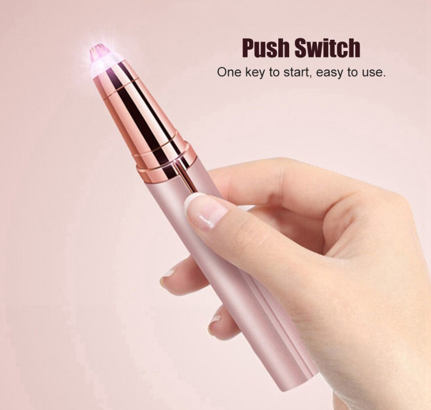 Hand holding a pink electronic device with a push switch on a light pink background